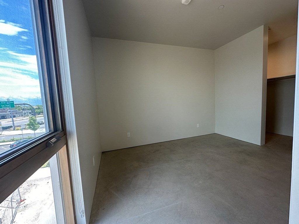 an empty living room with a large window