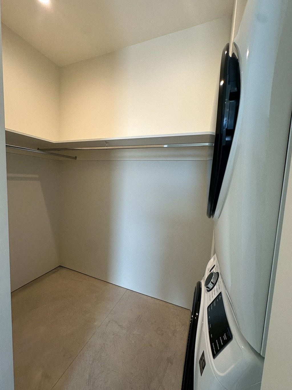 an empty room with a refrigerator and a washing machine