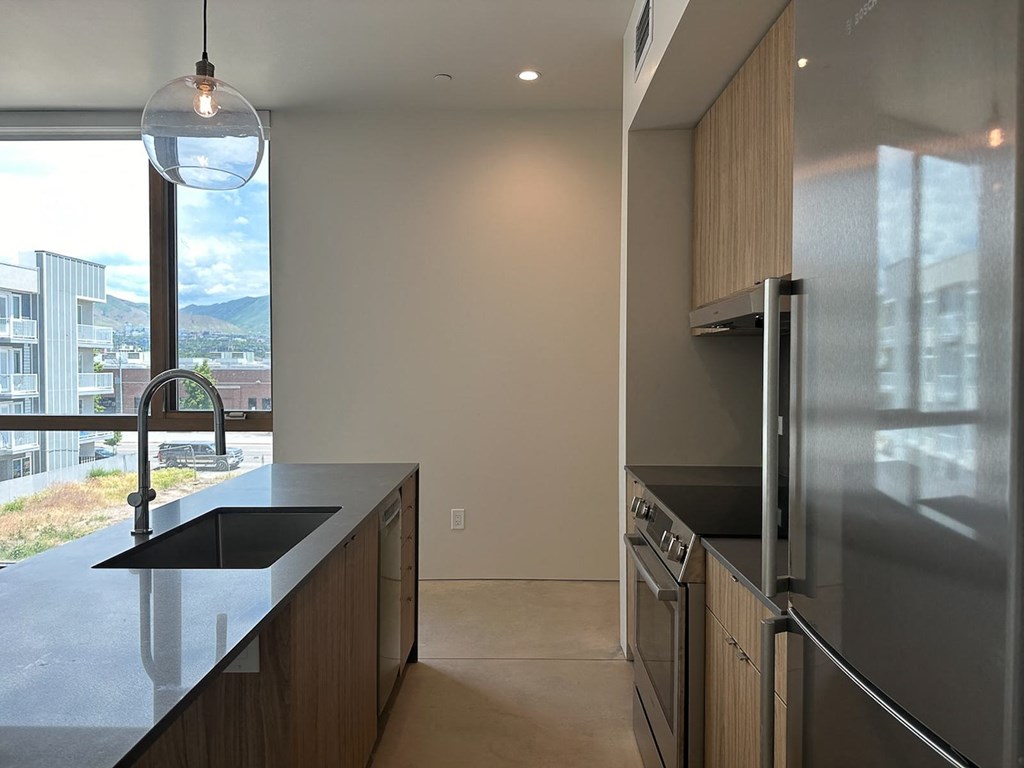 a kitchen with a sink and a large window