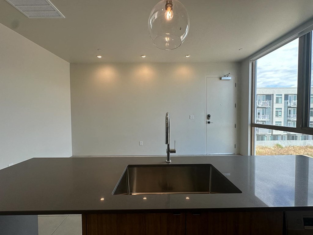 a kitchen with a sink and a large window