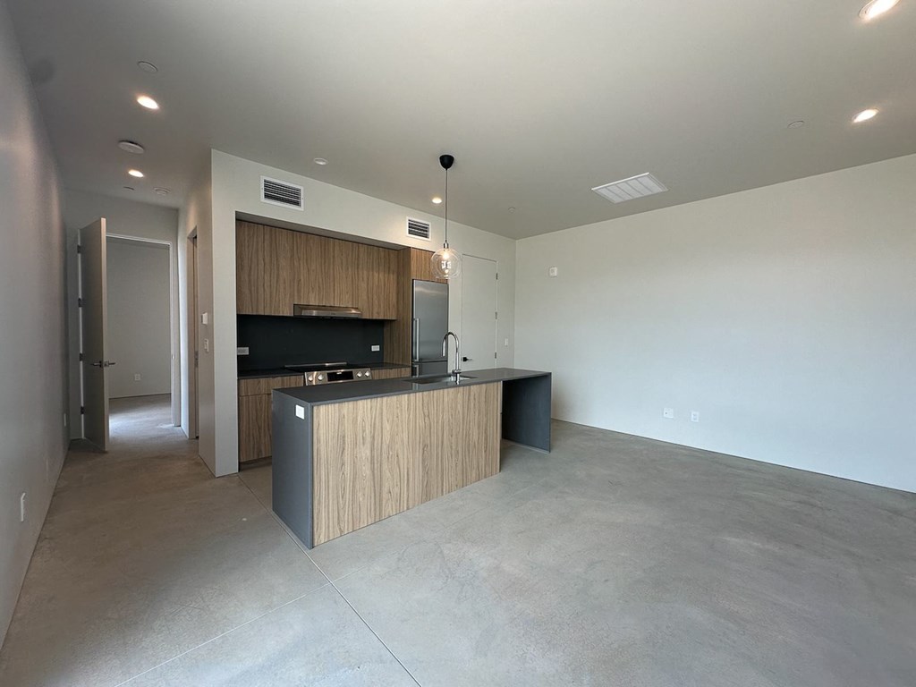 a kitchen with a large island in the middle of a living room