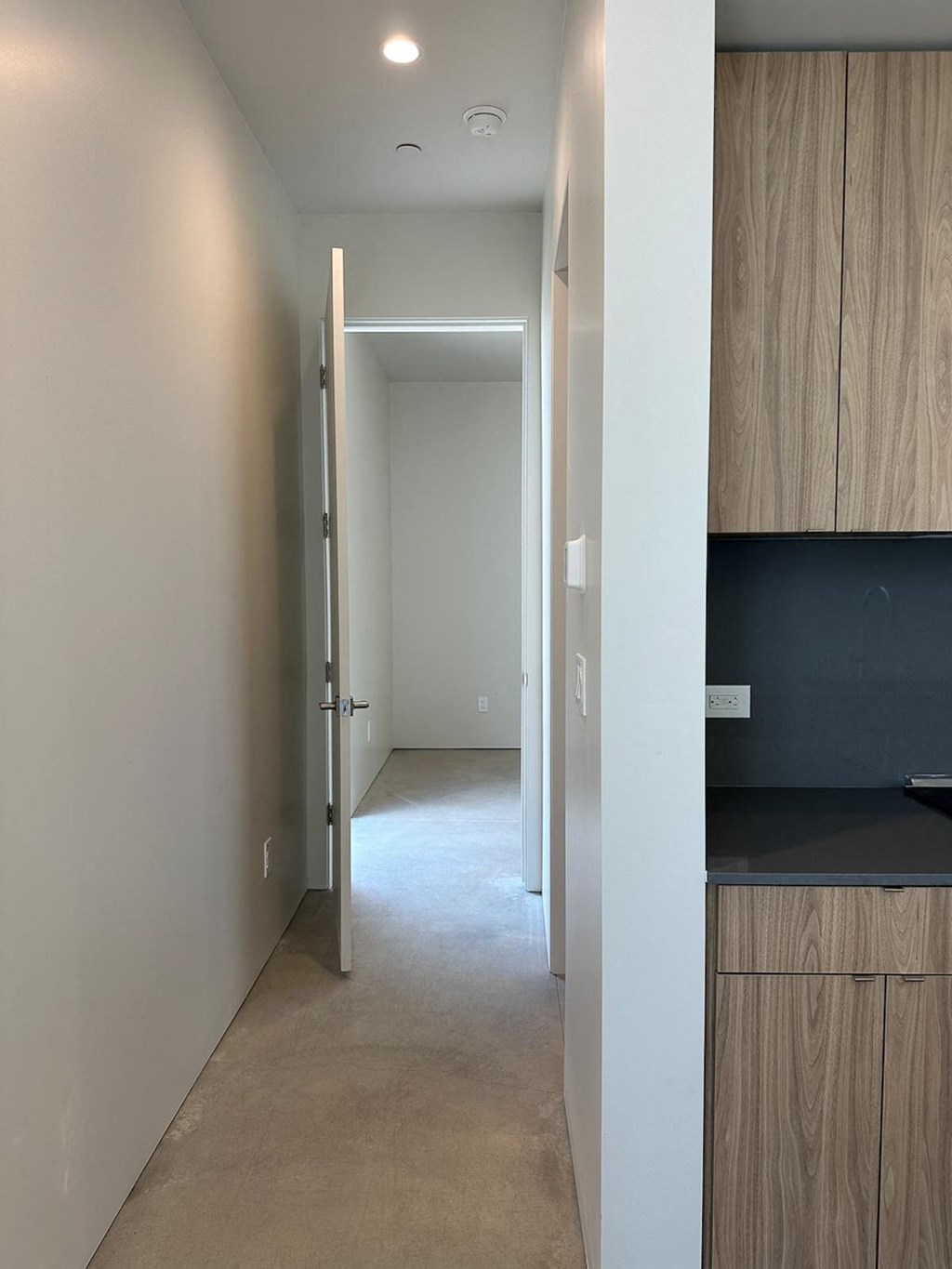 a hallway in a home with white walls and doors