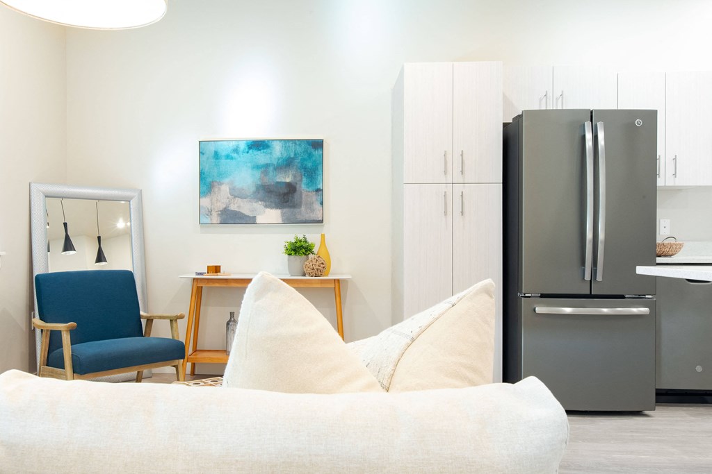 a living room with a couch and a refrigerator