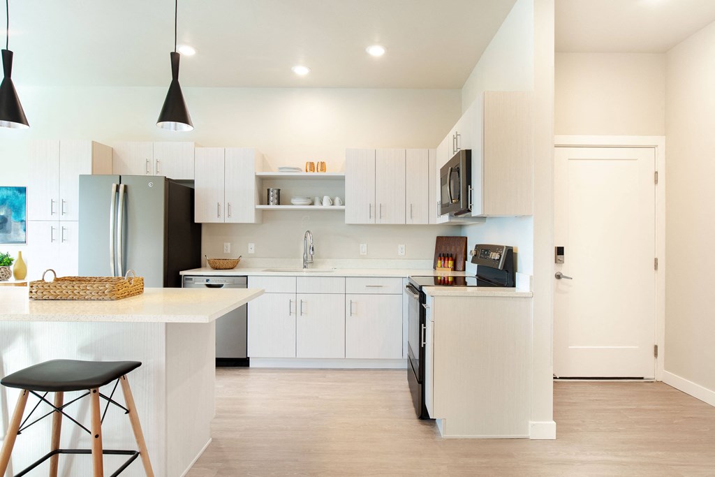 a kitchen with white cabinets and a white counter top