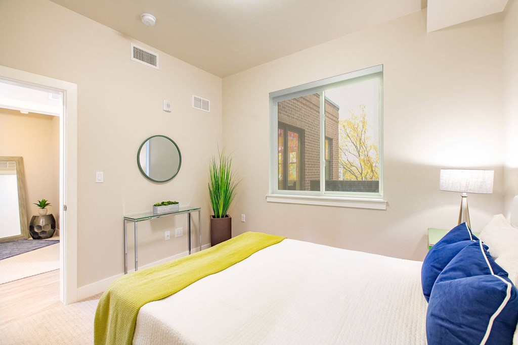 a bedroom with a large bed and a window