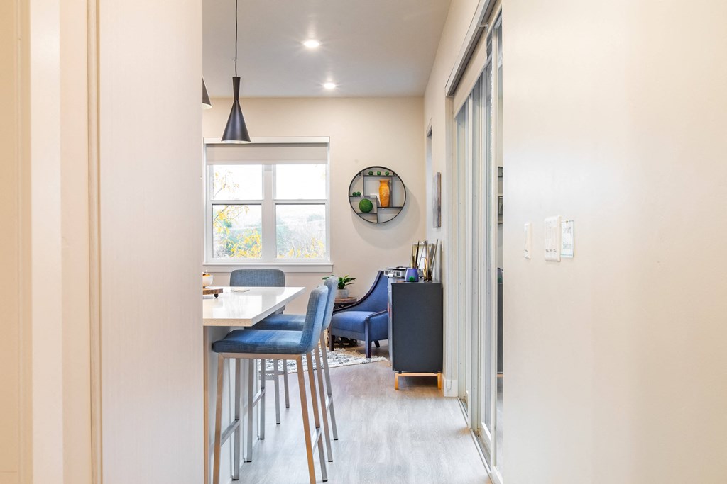 a kitchen and dining area with a table and chairs and a window