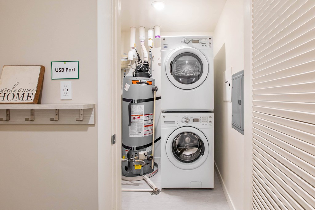 a white laundry room with a washing machine and a dryer