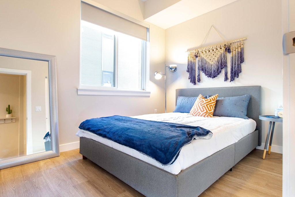 a bedroom with a bed and a mirror