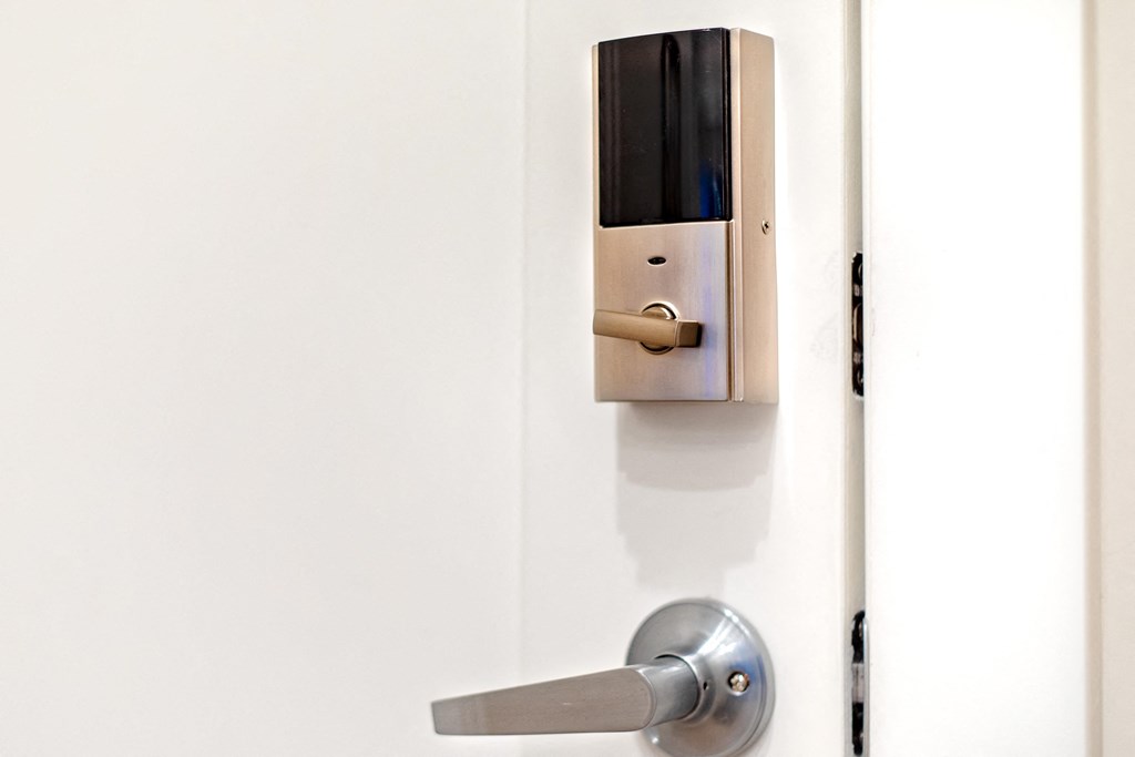 an open door with a door handle and a smart lock