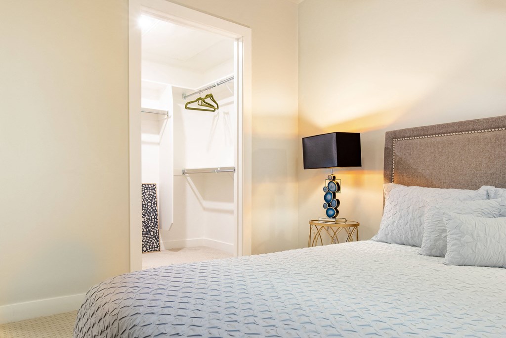 a bedroom with a bed and a door to a bathroom