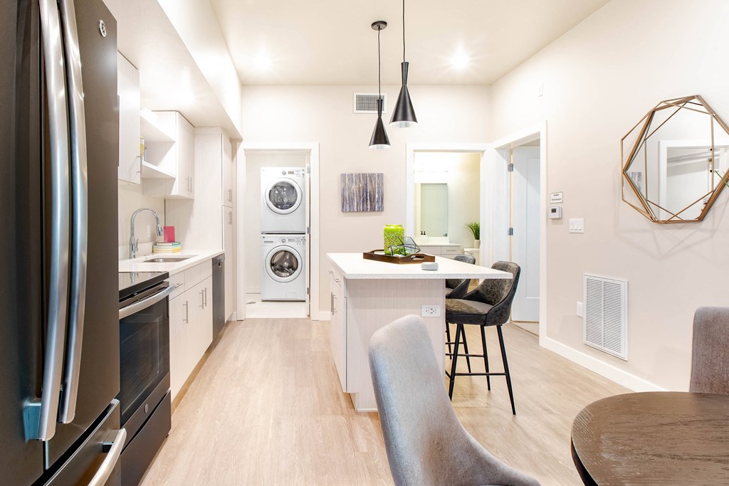 a kitchen and dining area with a washer and dryer and a counter top