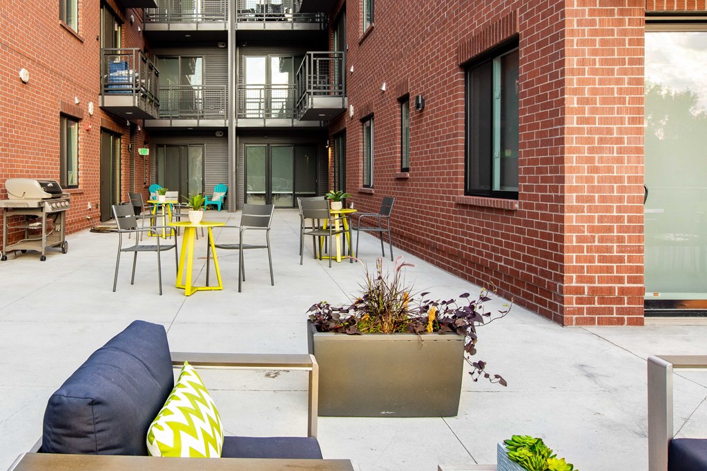 our apartments have an outdoor patio with tables and chairs