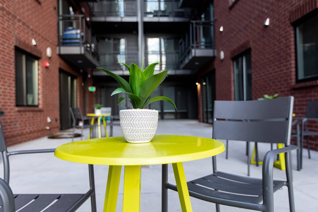 a yellow table with a potted plant on top of it