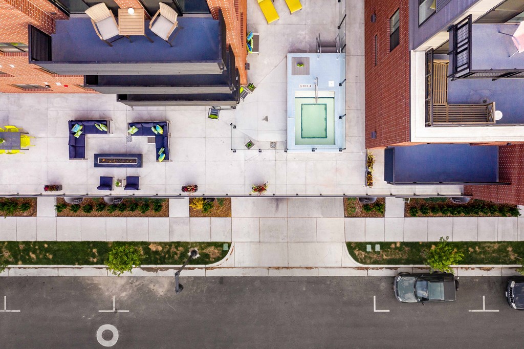 a birdseye view of a building with a blue door and a white facade