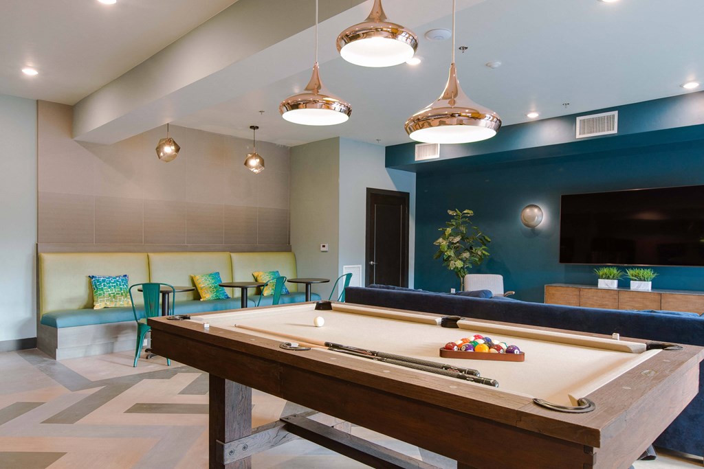 a game room with a pool table and a tv