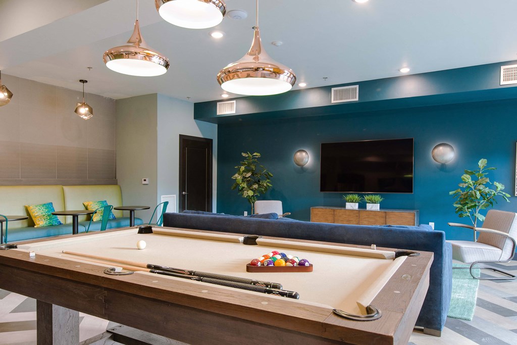 a pool table in a living room with a tv