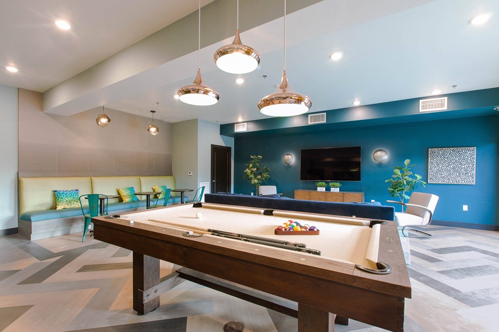 a game room with a pool table and a tv
