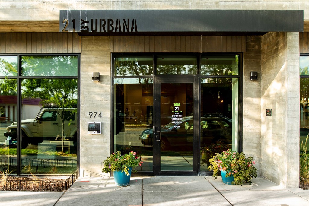 the front of a restaurant with glass doors and a black awning