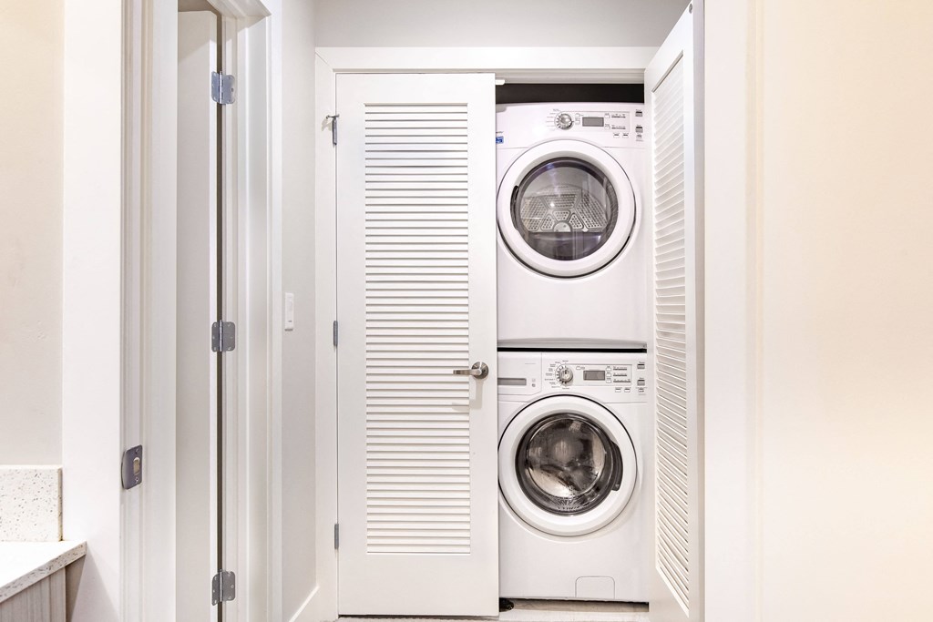 a white laundry room with a washer and a dryer