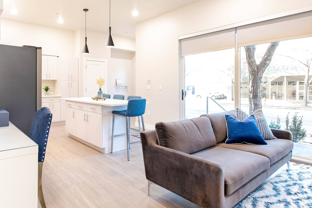a living room with a couch and a kitchen