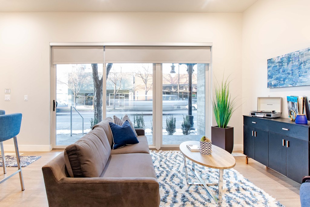 a living room with a couch and a coffee table and sliding glass doors