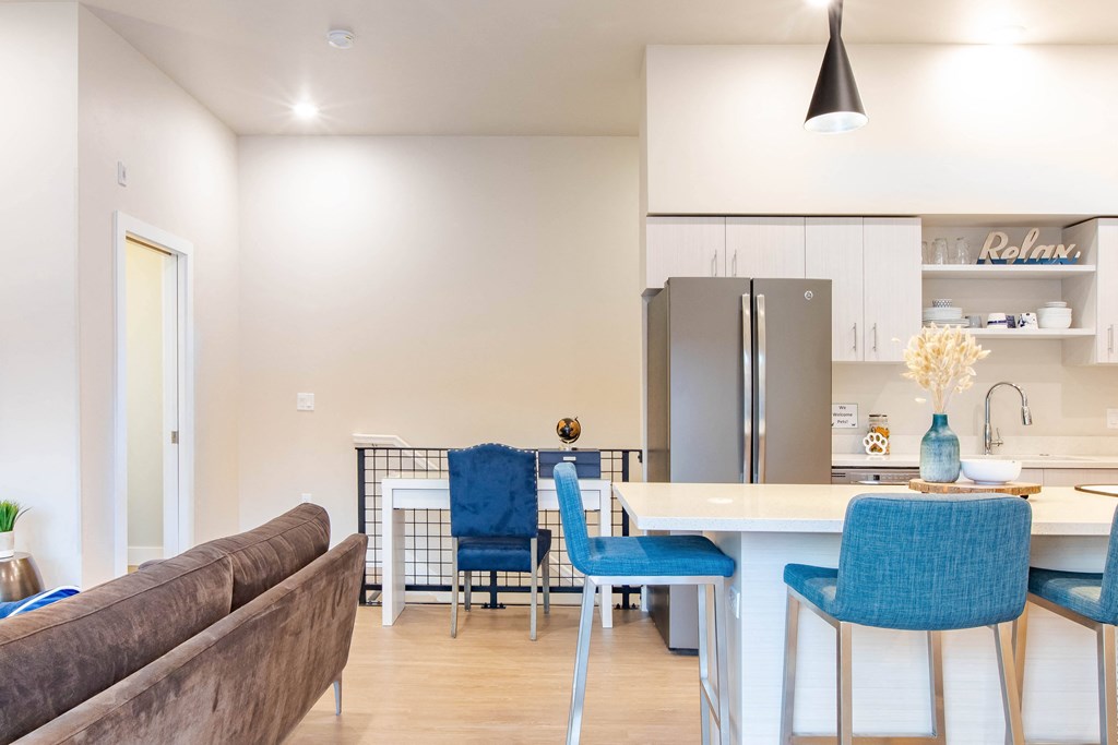 a living room and kitchen with a table and chairs