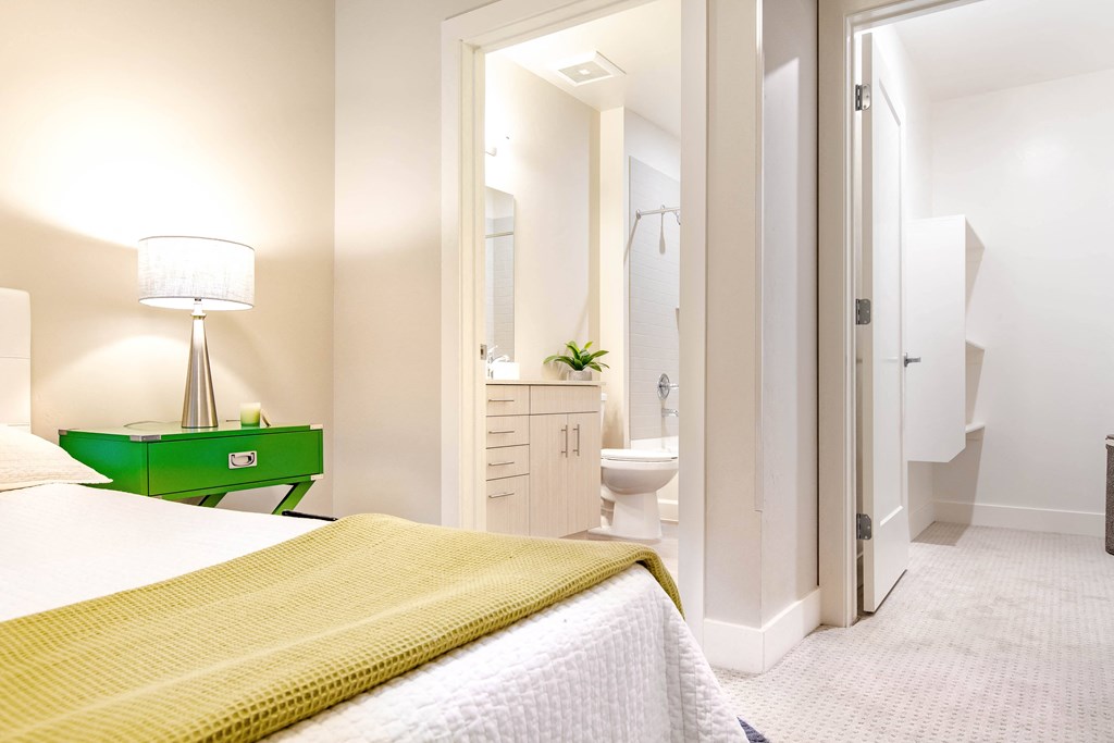 a bedroom with a bed and a bathroom with a toilet