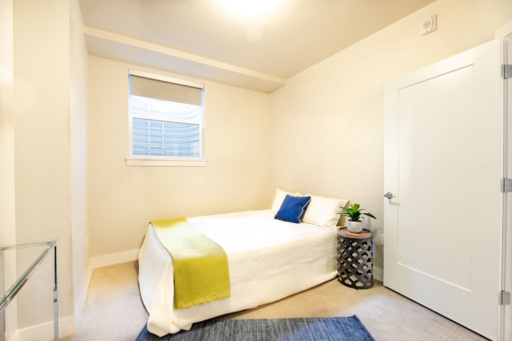 a bedroom with a bed and a window