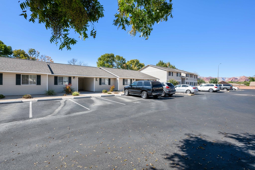 a parking lot with cars in front of a building