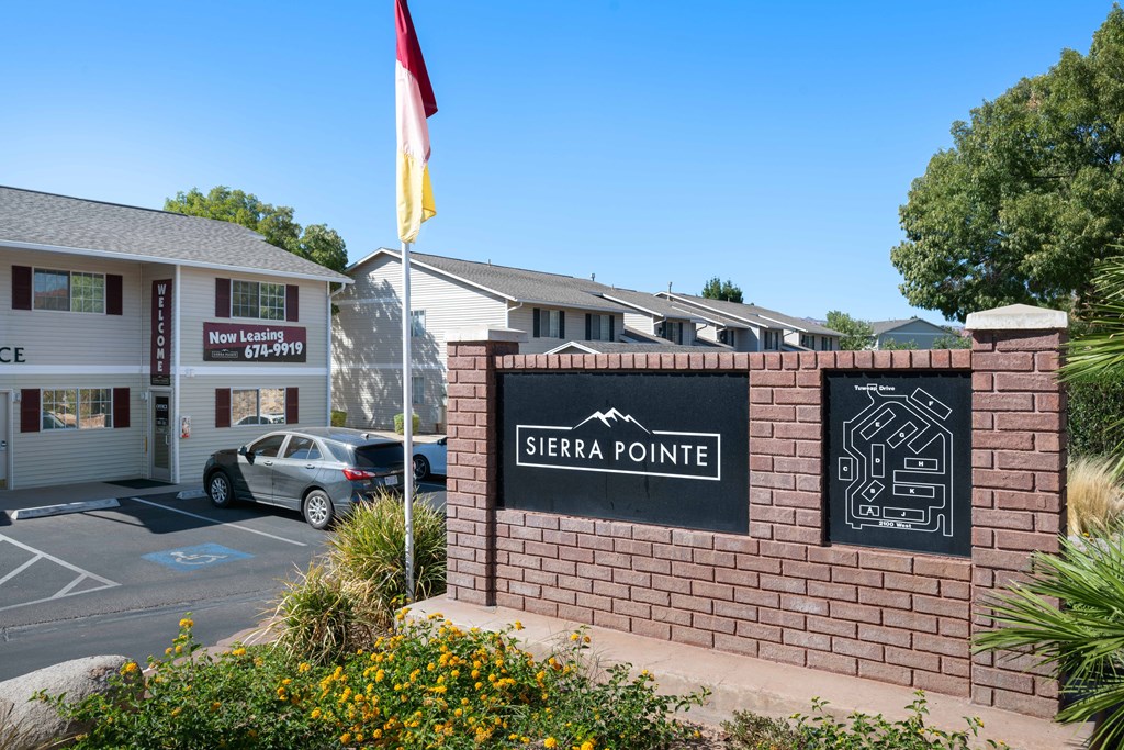 a brick wall with a sign for sierra pointe in front of a building