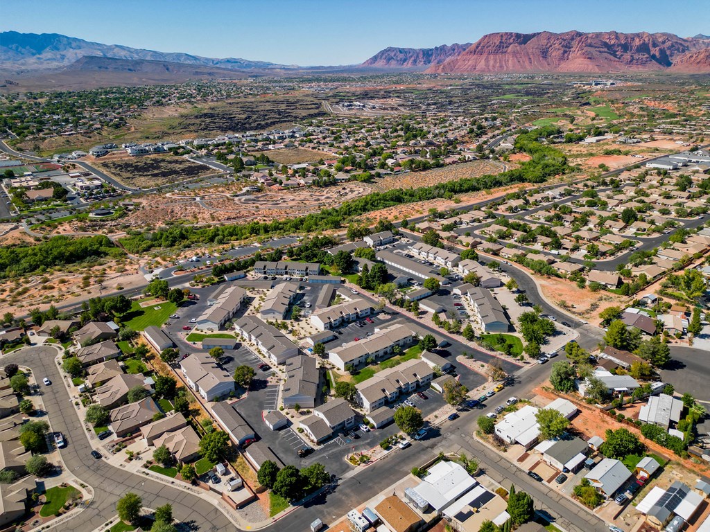 an aerial view of a suburban neighborhood with mountains in the background