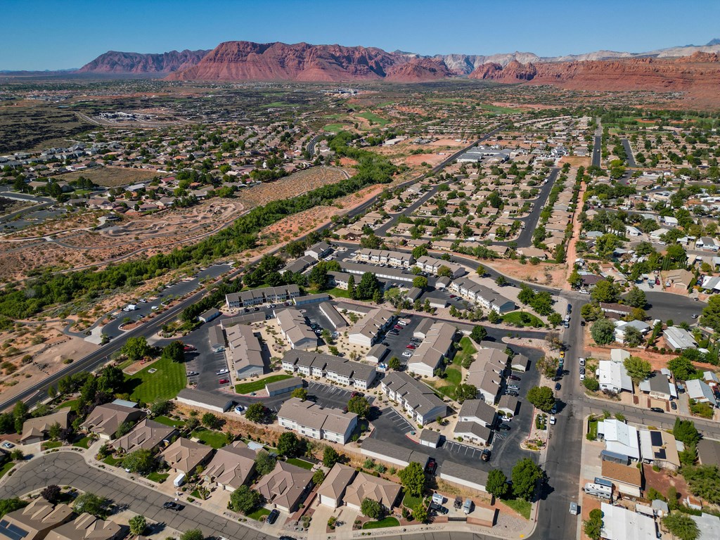 an aerial view of a suburban neighborhood with mountains in the background
