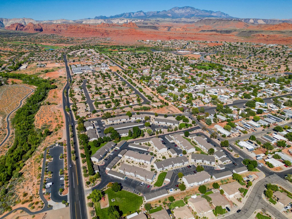 an aerial view of a city with mountains in the background