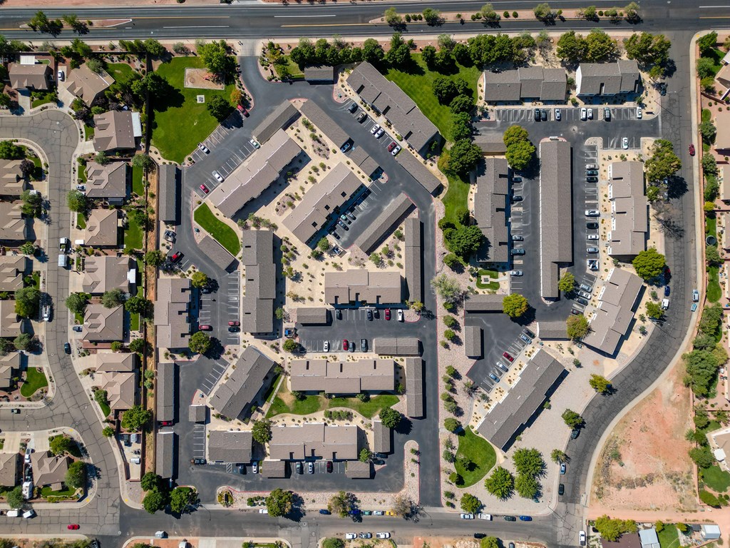 an aerial view of a city with houses and cars