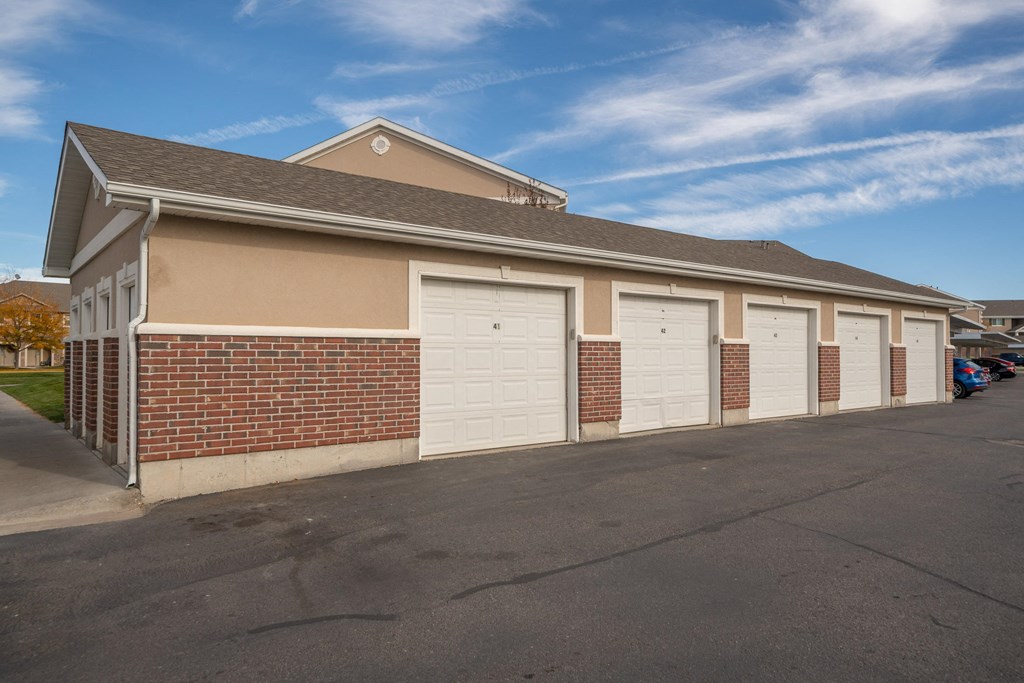 a brick building with white garage doors