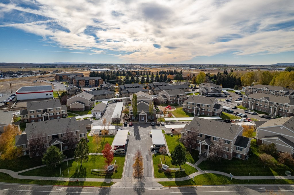 an aerial view of a neighborhood with houses and a city in the background