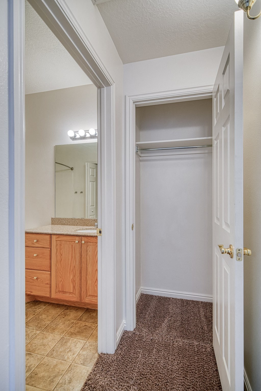 a bedroom with a bed and a mirror