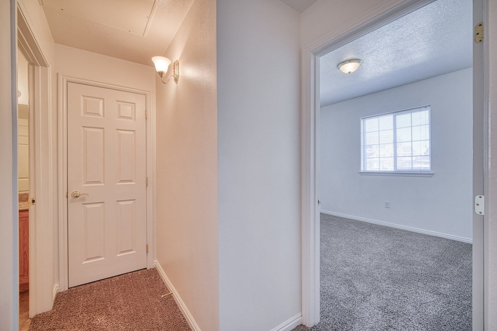 a bedroom with a door and a window