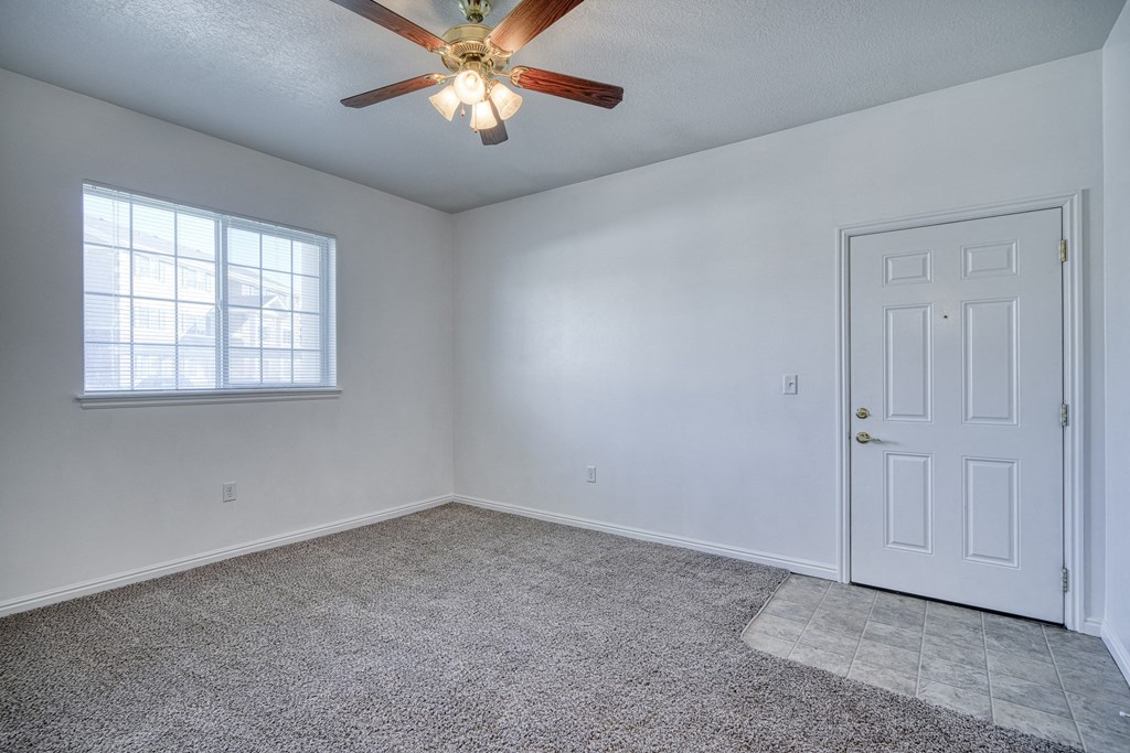 a bedroom with a ceiling fan and a window
