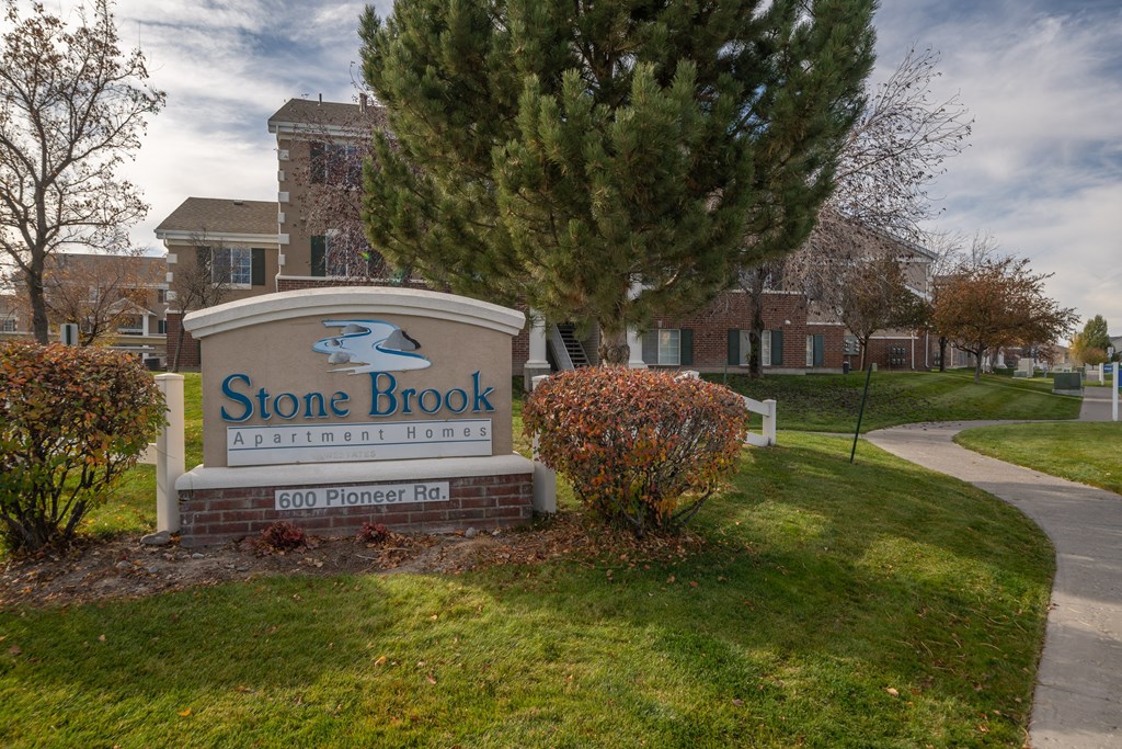 a stone brook sign in front of a brick building