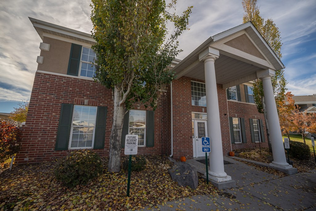 a brick building with two pillars and a sign in front of it