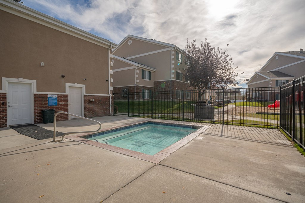 a pool at the whispering winds apartments in pearland, tx