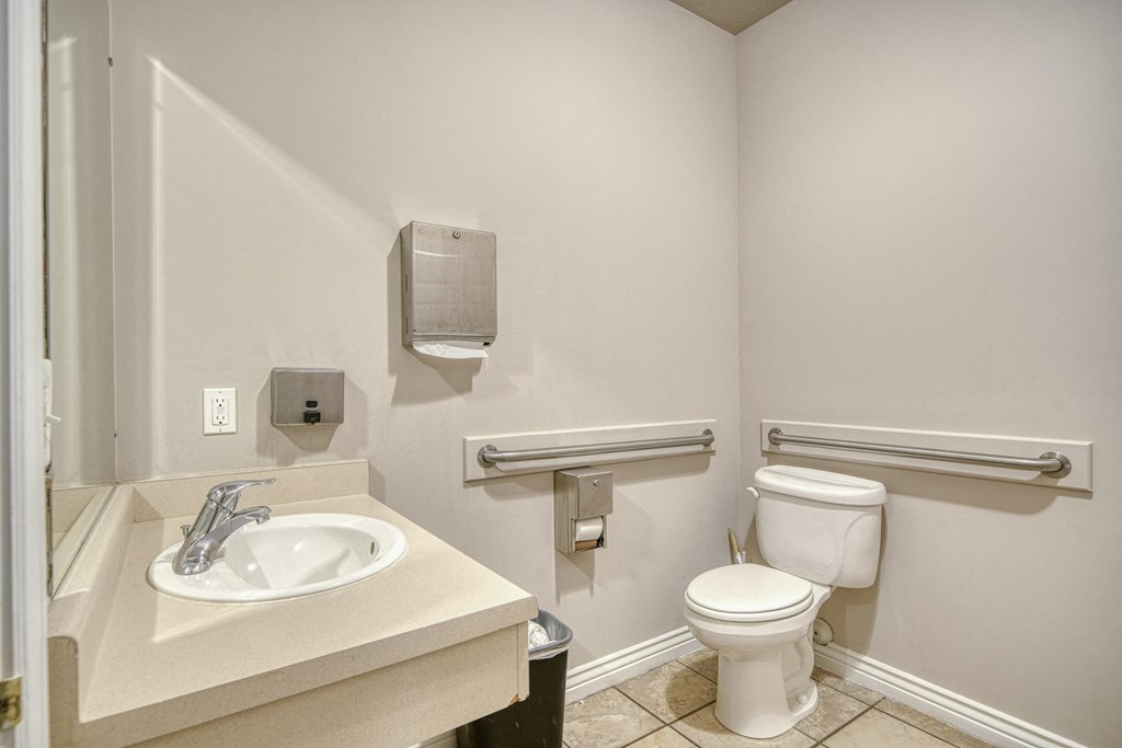 a bathroom with a sink toilet and mirror