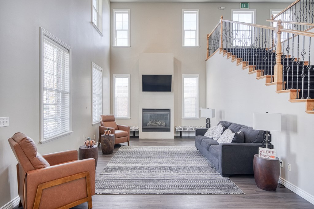 a living room with a couch chairs and a fireplace