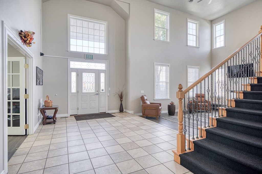 a view of the entryway of a house with a tiled floor and a staircase