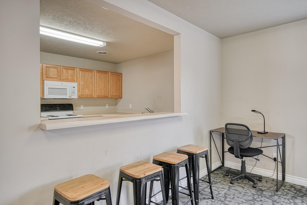a room with a small table and four stools