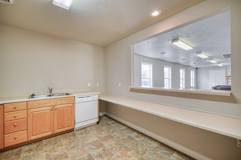 a kitchen with a sink and a mirror