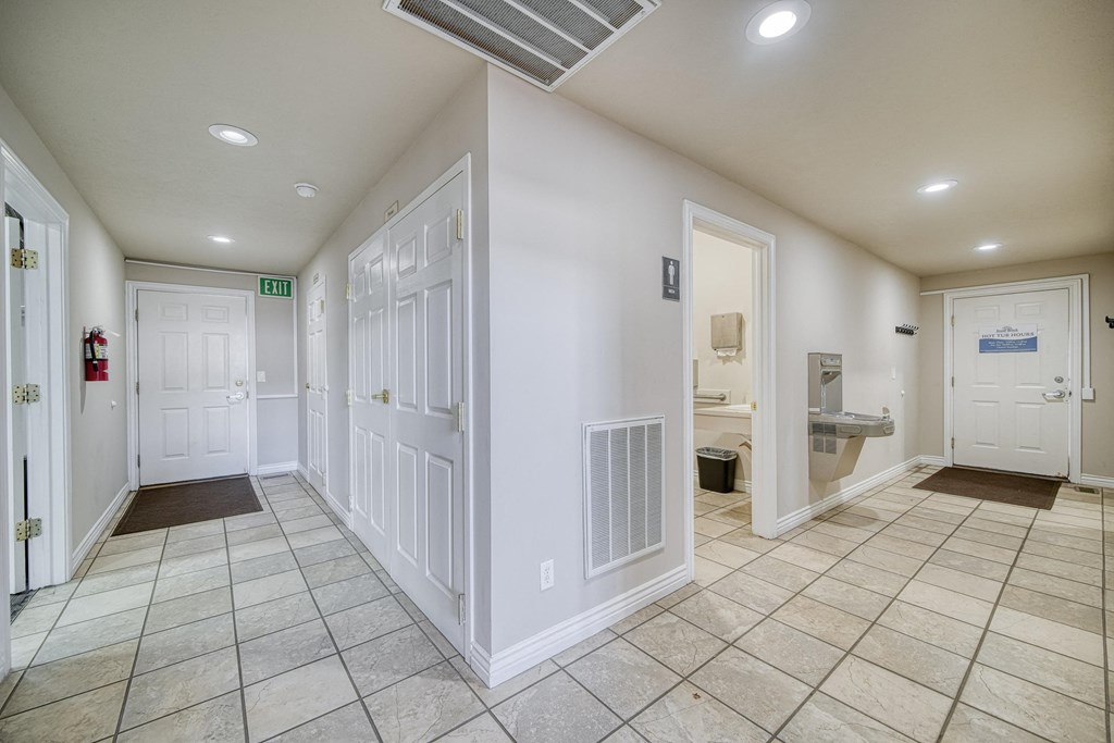 a hallway with a tiled floor and white walls