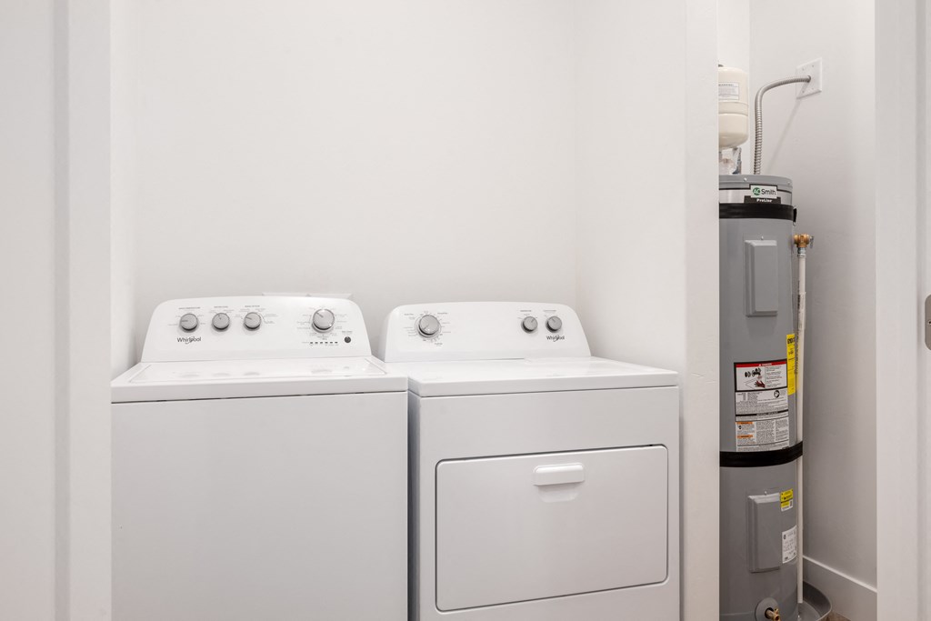 a washer and dryer in a room with a refrigerator