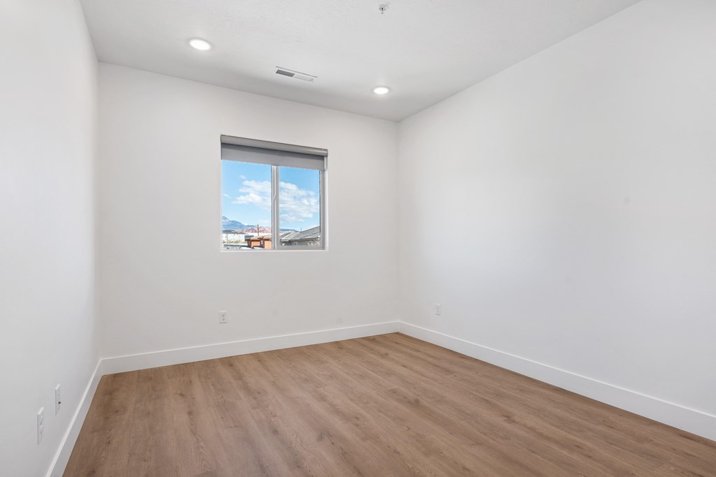 an empty room with white walls and a window